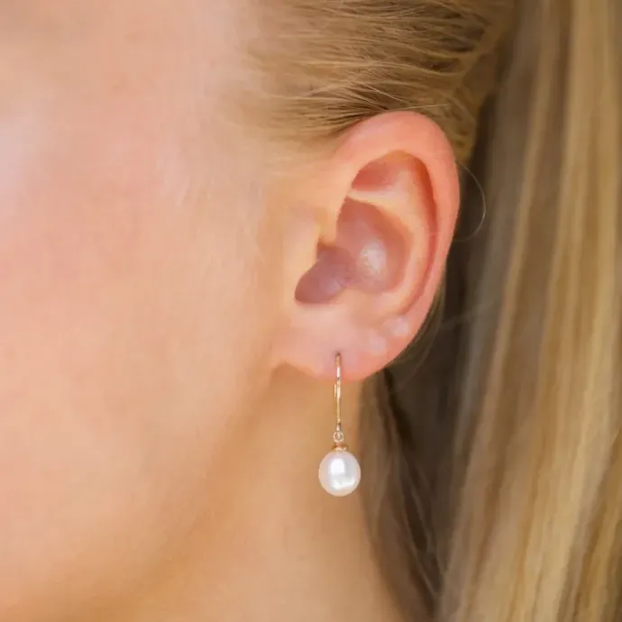 Ovale 7 - 8 mm aaa-graded ferskvandsperle øreringe i 14 karat guld med